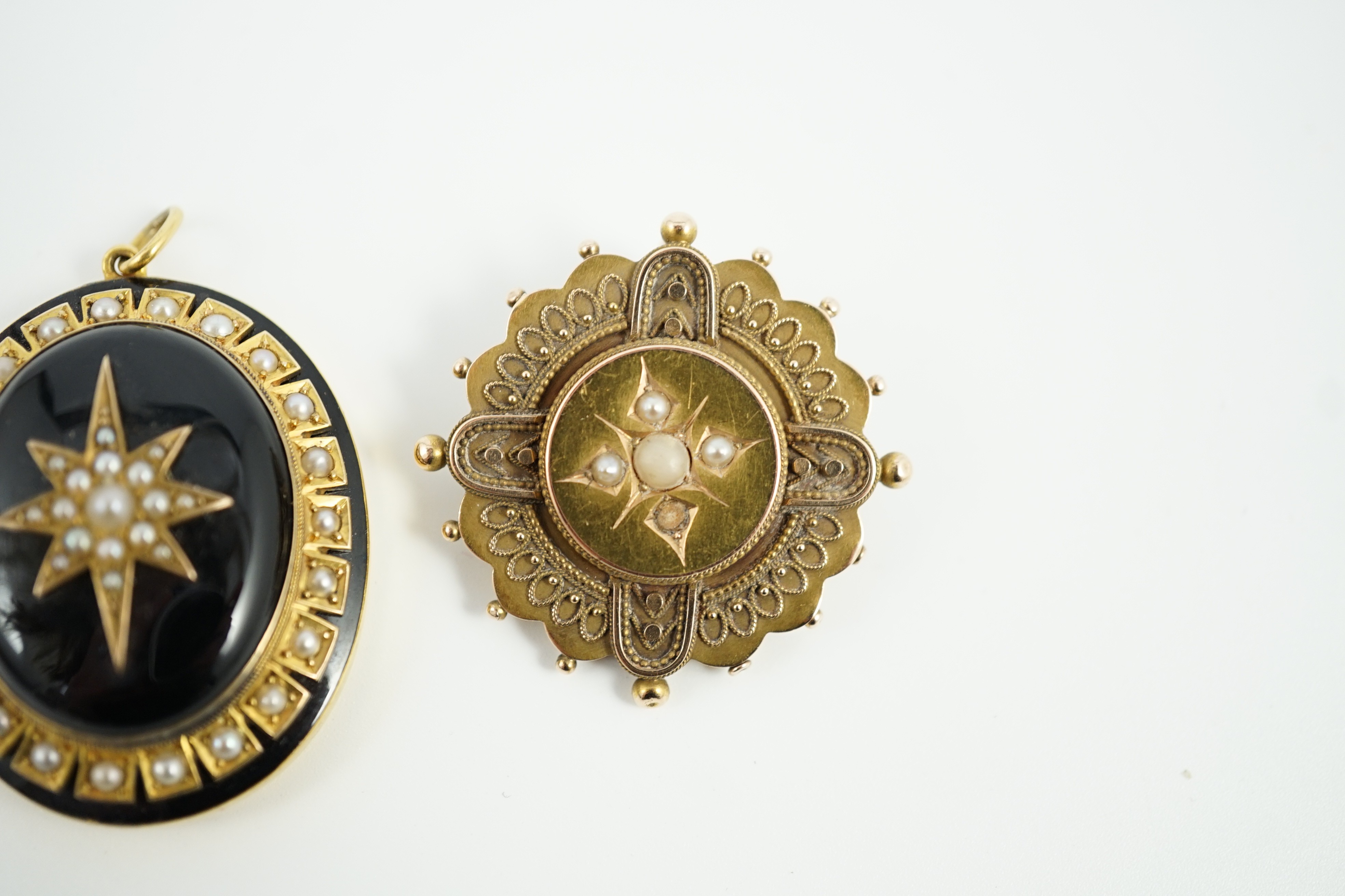 A Victorian yellow metal, black onyx, black enamel and split pearl set oval mourning pendant, 41mm and a Victorian 15ct, coral? and seed pearl set brooch, gross weight 21.5 grams.
